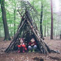 Children having fun building dens during a forest school session